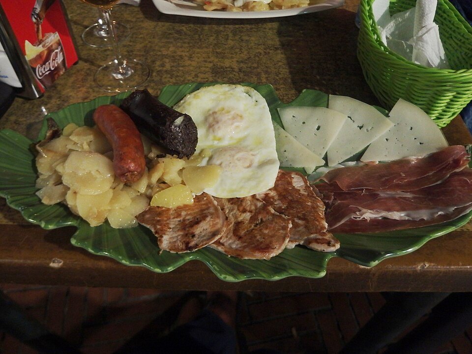 The plato alpujarreño from the mountains behind the city: egg, potatoes, cured pork and morcilla on one plate.